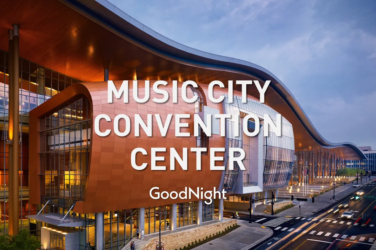 A dynamic exterior shot of a modern building with unique architectural design, large glass windows, and illuminated signage. The setting is lively, suggesting this is a major venue for conferences, trade shows, and community events—capturing the bustling energy of Nashville’s business scene.
